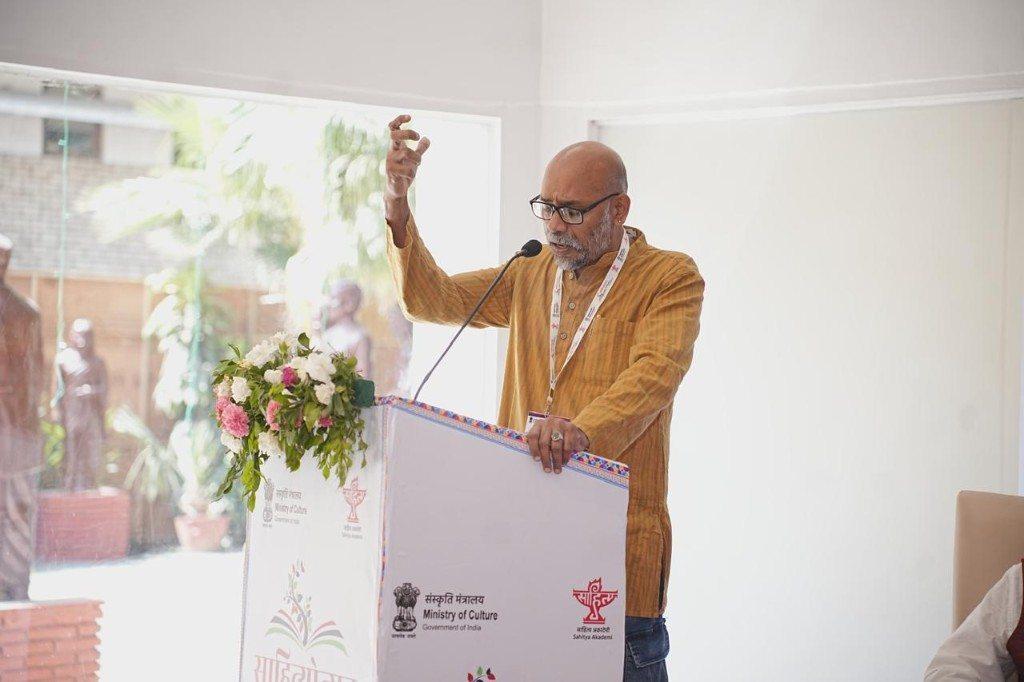 O.P. Suresh speaking at a lectern marked Ministry of Culture, Government of India, and Sahitya Akademi.